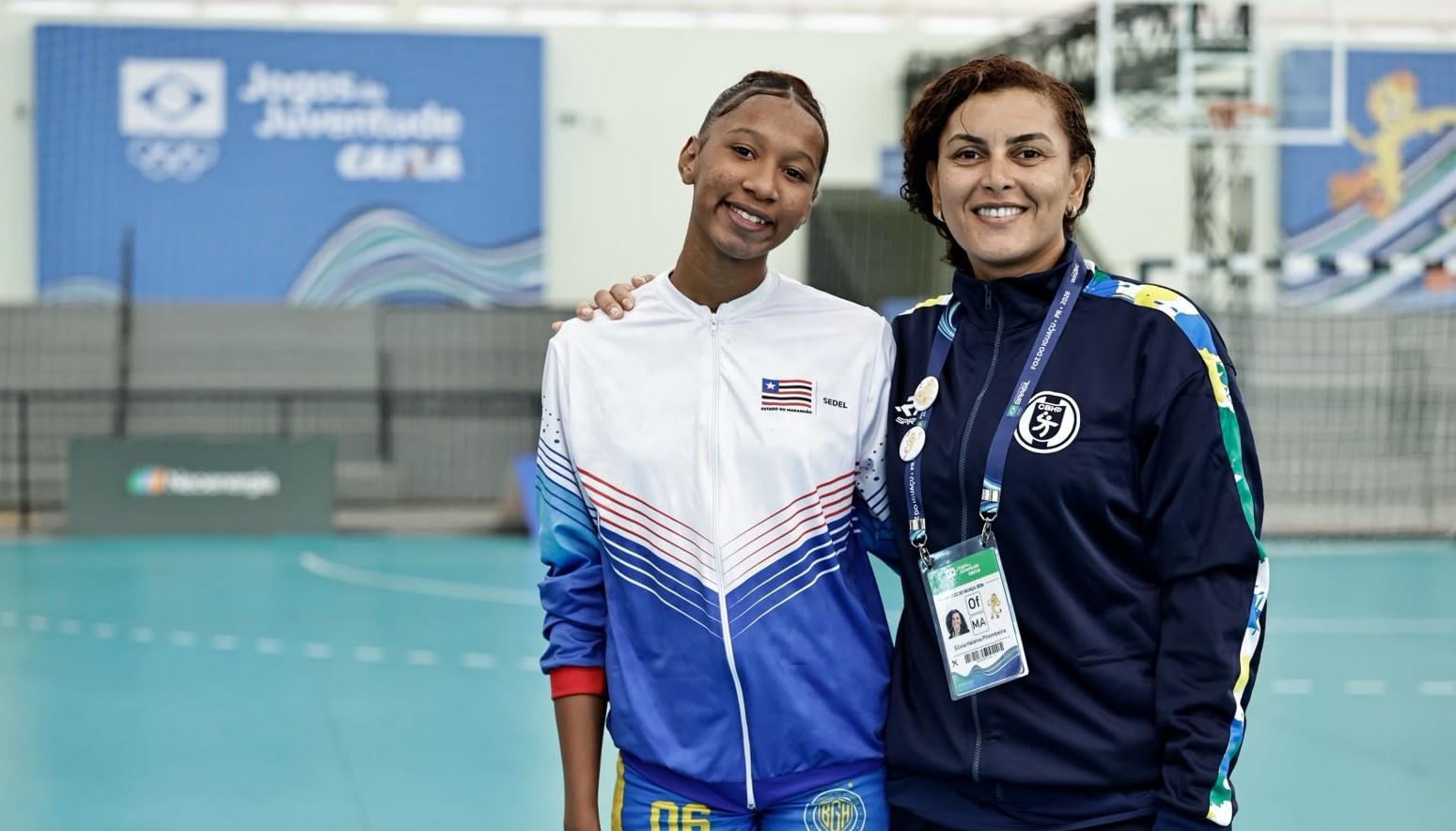 Silvia Helena e sua sobrinha, Any Gabrielle, nos Jogos da Juventude CAIXA Foz do Iguaçu 2026. Foto: Carol Coelho Silvia Helena, ex-atleta olímpica de handebol, vive Jogos da Juventude CAIXA na comissão técnica do Maranhão ao lado de sobrinha